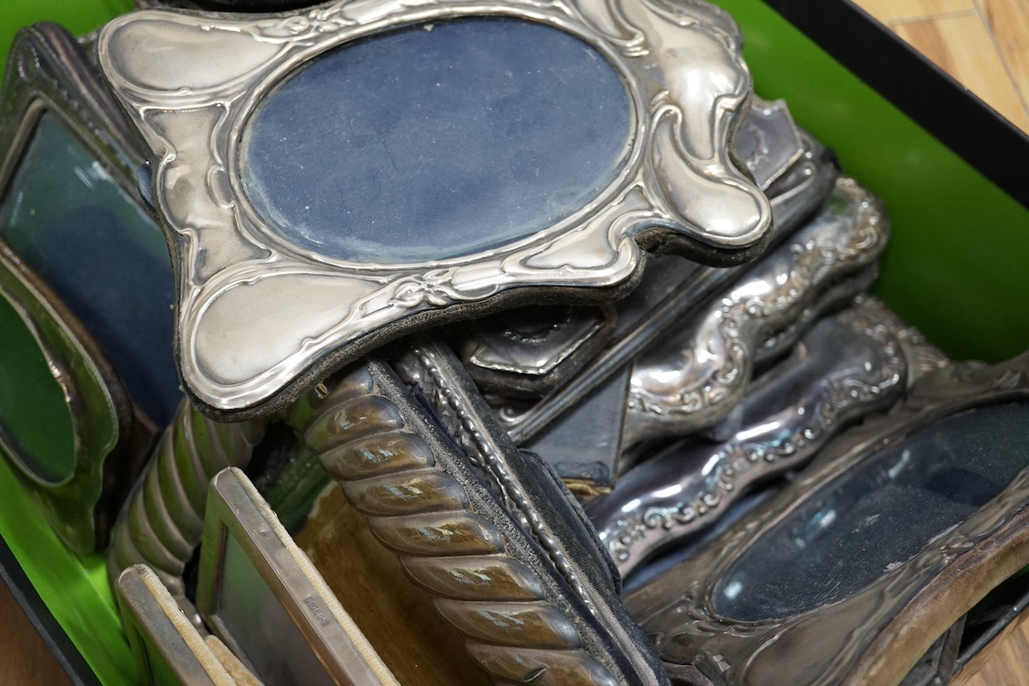 A George V plain silver mounted rectangular photograph frame by Asprey & Co, London, 1910, 12.4cm by 10cm, one other George V silver mounted oval photograph frame and fifteen other assorted modern silver mounted photogra